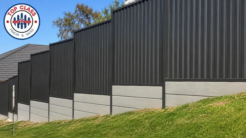 Concrete sleeper plinth installed under a Colorbond fence on a sloping boundary Concrete sleeper plinth installed under a Colorbond fence on a sloping boundary